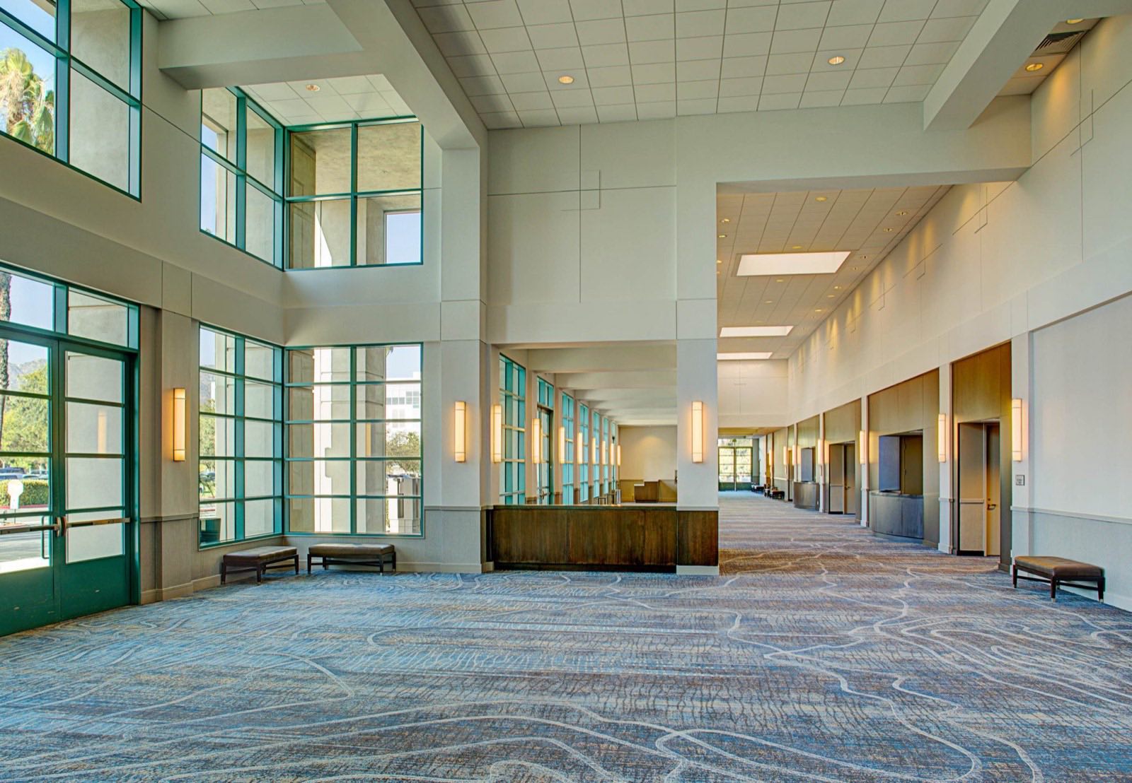 Sunlit grand foyer with two-story glass walls