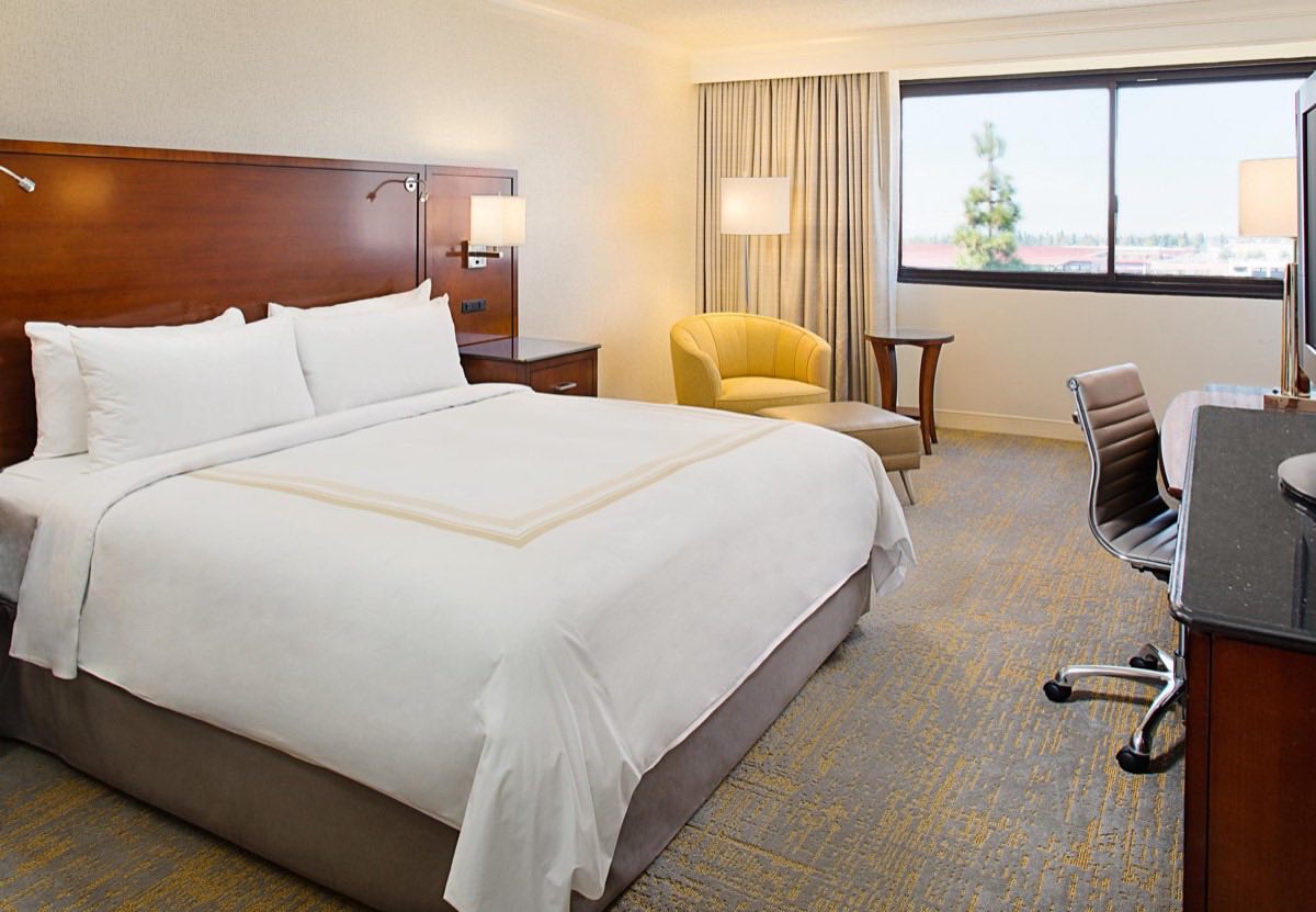 King guest room with warm wood headboard