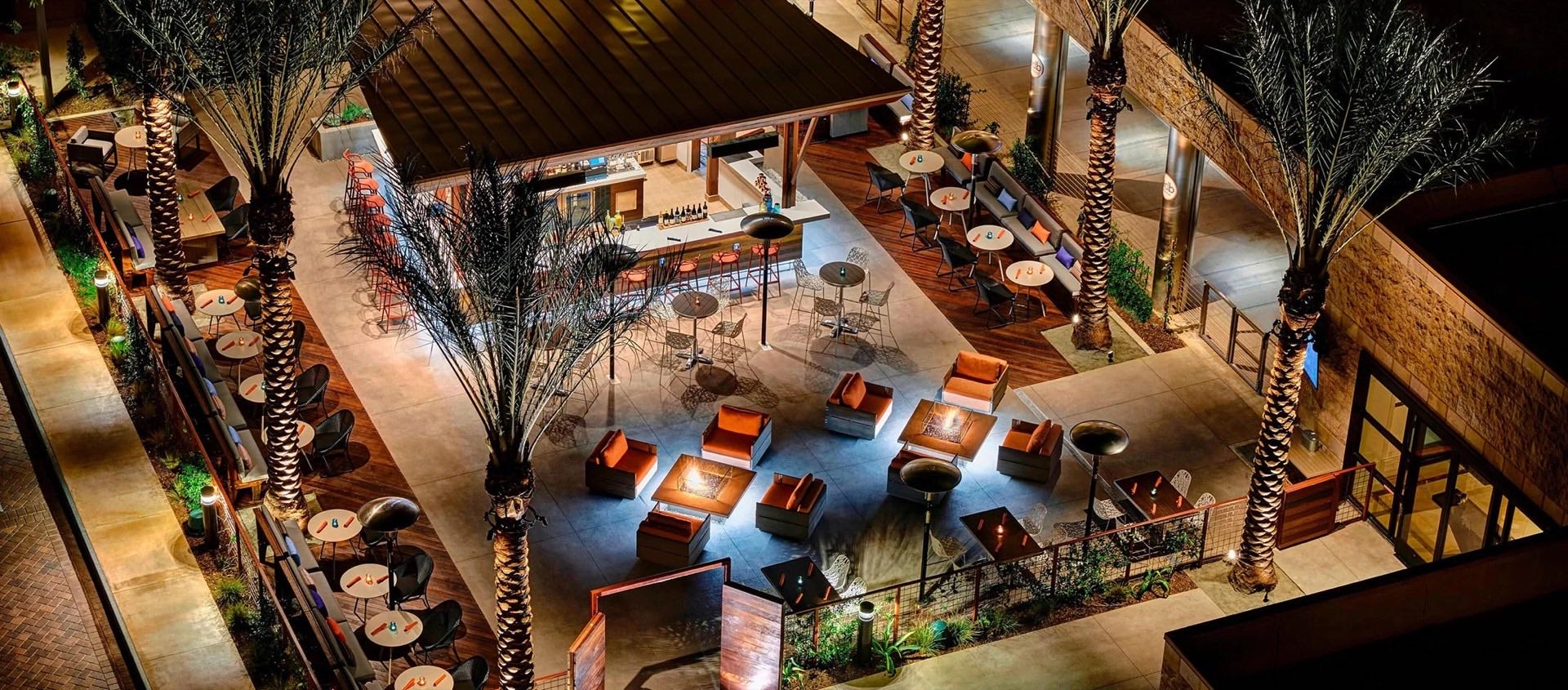 Aerial night view of the fire-lit E.D.B. outdoor lounge
